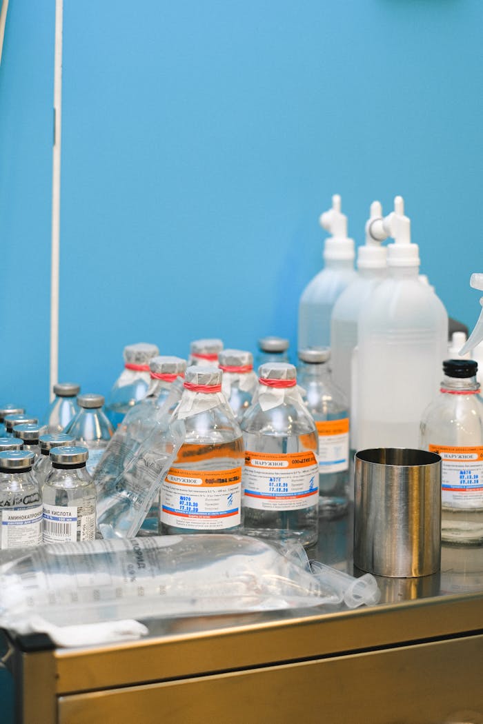 Selection of medical supplies on a table in a laboratory setting with blue wall.