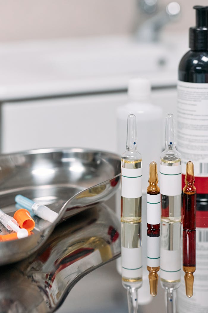 Close-up of medical vials and syringes in a sterile clinic environment, emphasizing healthcare and treatment.