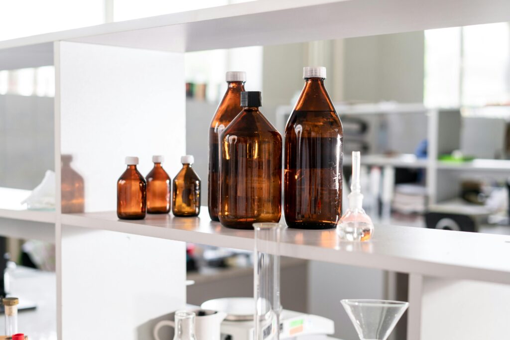 Brown glass bottles on a laboratory shelf, ideal for science-related contexts.